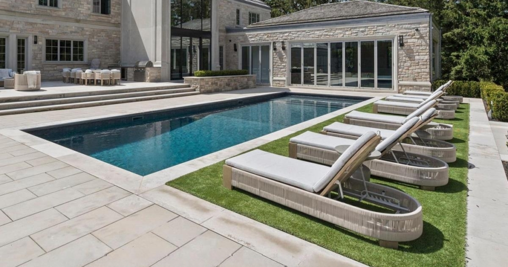 Bright custom home living room with statement fireplace and oversized windows in Toronto
