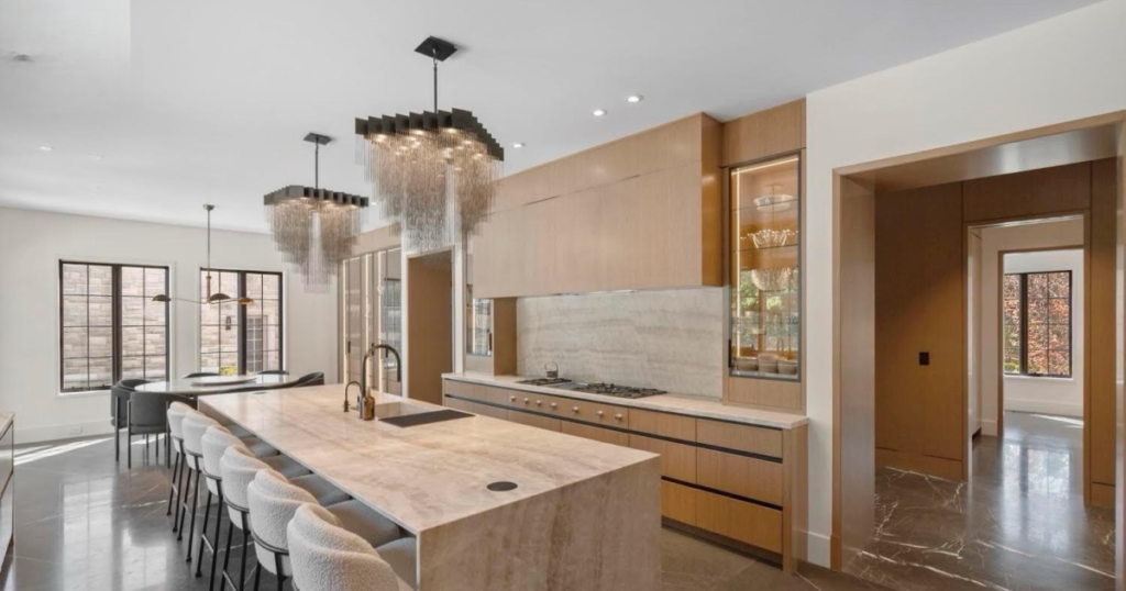 Upscale kitchen renovation with high-gloss finishes and pendant lighting in Toronto home.