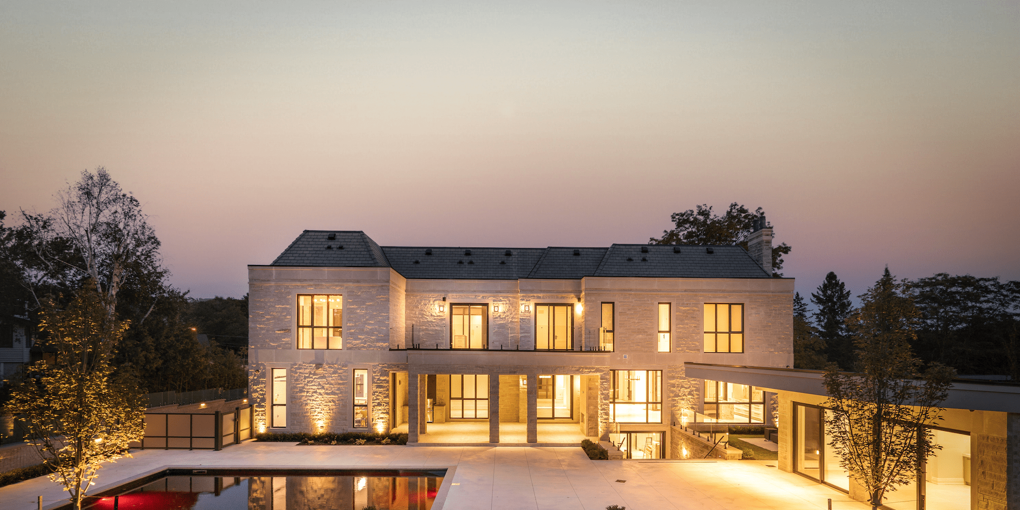 Front elevation of luxury custom Oakville residence with double-height entry and stone detailing.