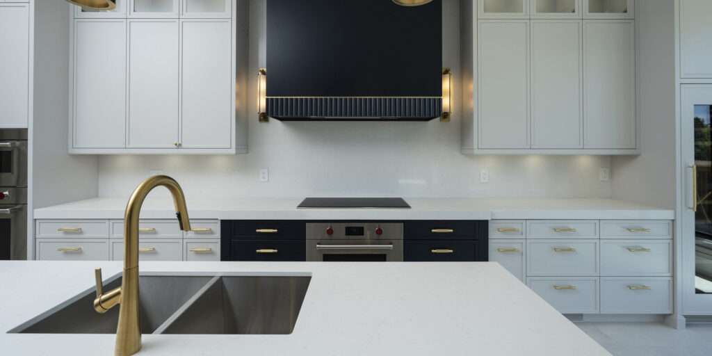 Sleek modern kitchen with minimalist cabinetry and integrated appliances in Forest Hill custom home.